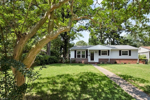 ranch-style house featuring a front yard and brick siding