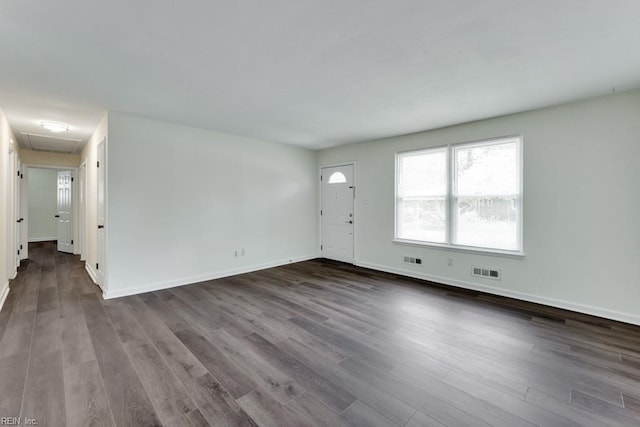 unfurnished living room with dark wood finished floors and baseboards