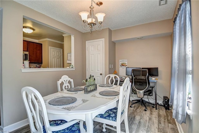 5120 Bardith Cir, Virginia Beach, VA 23455 - dining space with wood finished floors, a chandelier, a textured ceiling, and baseboards