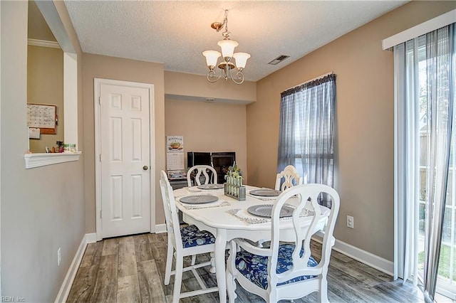 5120 Bardith Cir, Virginia Beach, VA 23455 - dining room with a chandelier, wood finished floors, baseboards, and a textured ceiling