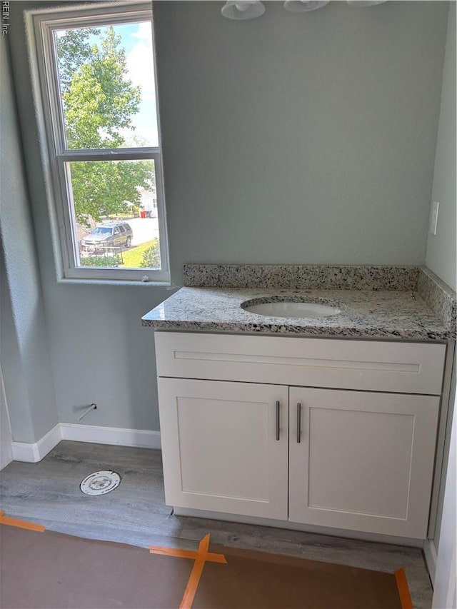 419B Elcinoca Dr, Elizabeth City, NC 27909 - bathroom featuring wood finished floors, vanity, and baseboards
