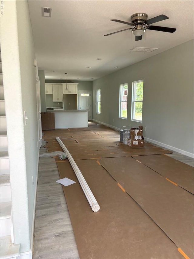 419B Elcinoca Dr, Elizabeth City, NC 27909 - unfurnished living room featuring ceiling fan and baseboards