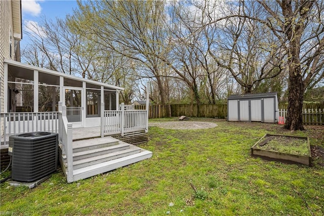 1309 W 25th St, Norfolk, VA 23508 - view of yard featuring a sunroom, a shed, central AC unit, an outbuilding, and a garden