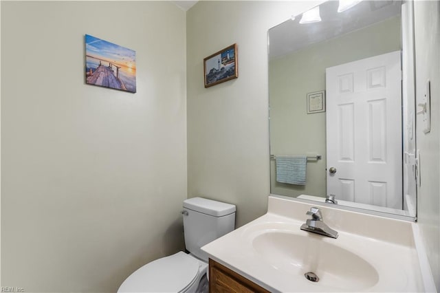 bathroom featuring toilet and vanity