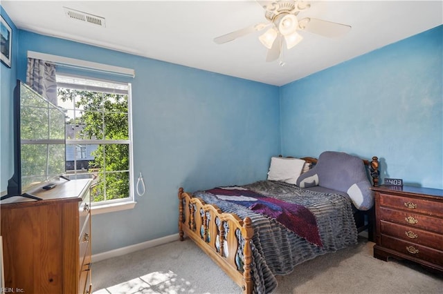 carpeted bedroom with multiple windows, baseboards, and ceiling fan