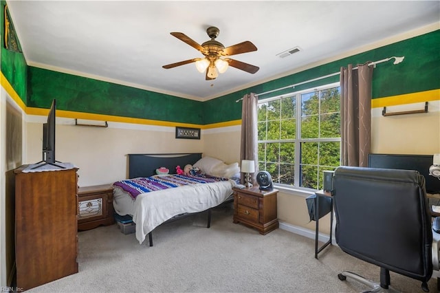 carpeted bedroom with a ceiling fan and baseboards