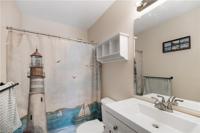 bathroom featuring toilet, vanity, and curtained shower