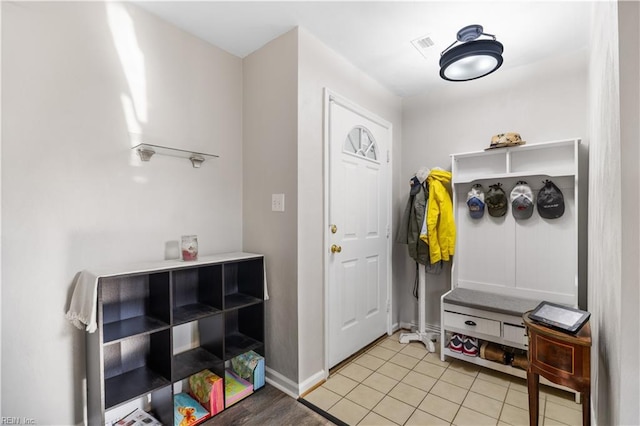 mudroom with baseboards and light tile patterned flooring