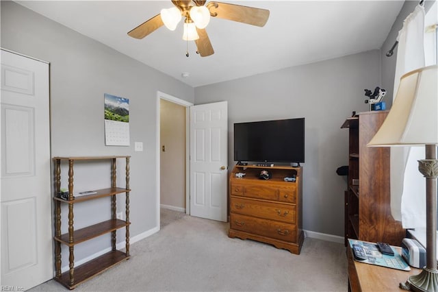 carpeted bedroom featuring baseboards and a ceiling fan