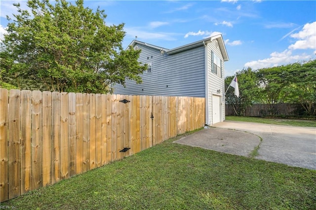 view of side of home featuring driveway and a garage