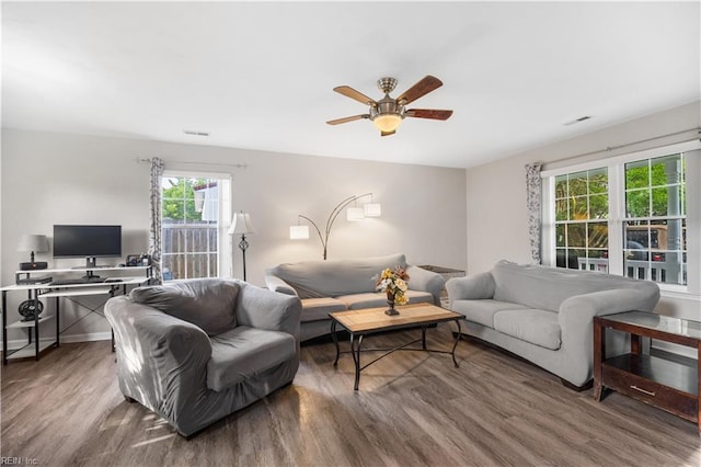 living room with wood finished floors and ceiling fan