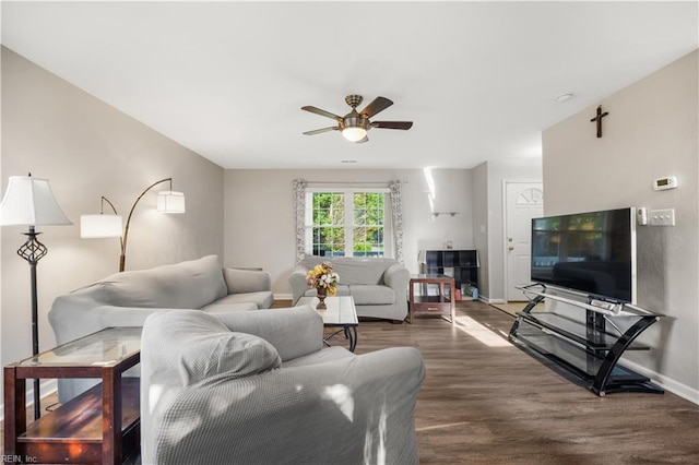 living area featuring ceiling fan, wood finished floors, and baseboards