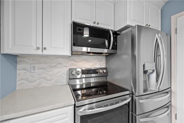 3513 Brigita Ct, Virginia Beach, VA 23453 - kitchen with appliances with stainless steel finishes, white cabinetry, decorative backsplash, tile patterned flooring, and light stone countertops