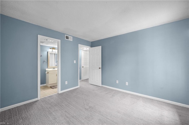 3513 Brigita Ct, Virginia Beach, VA 23453 - unfurnished bedroom featuring a textured ceiling, carpet floors, baseboards, and ensuite bathroom