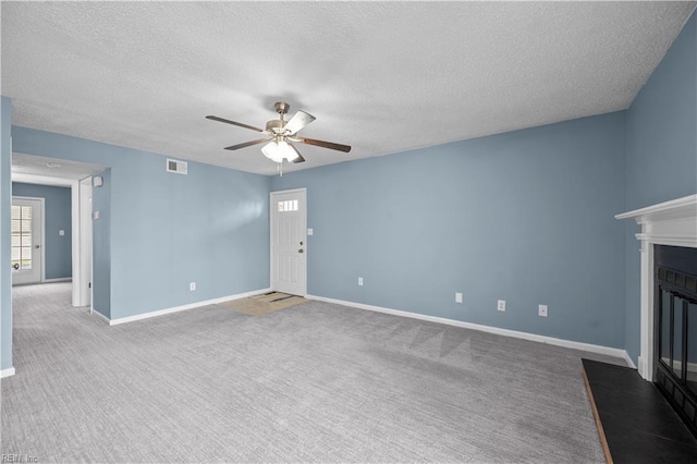 3513 Brigita Ct, Virginia Beach, VA 23453 - unfurnished living room with a ceiling fan, a textured ceiling, a fireplace with flush hearth, carpet floors, and baseboards