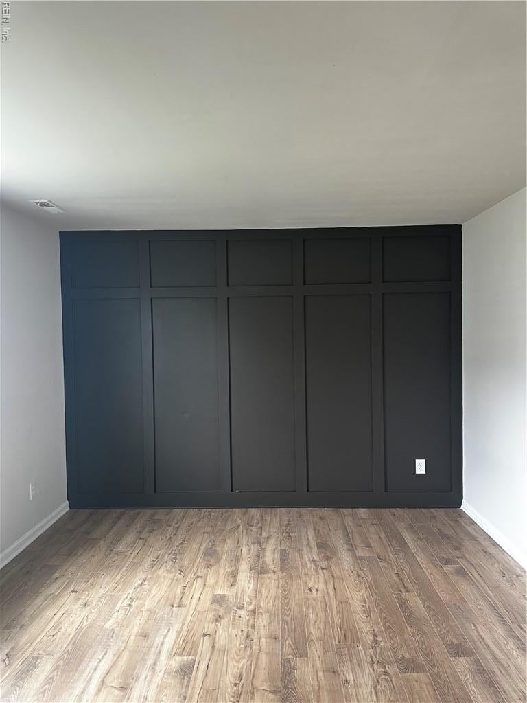 unfurnished room featuring light wood-style flooring and baseboards