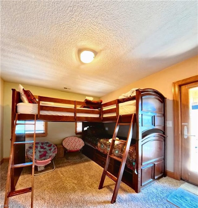 2390 Sandfiddler Rd, Corolla, NC 27927 - bedroom with a textured ceiling and carpet floors