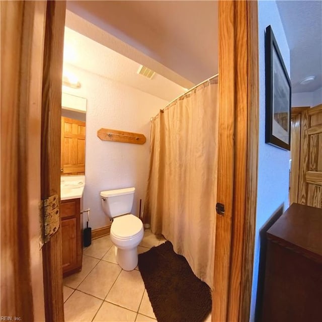 2390 Sandfiddler Rd, Corolla, NC 27927 - bathroom featuring vanity, tile patterned flooring, toilet, and a shower with shower curtain