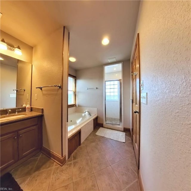 2390 Sandfiddler Rd, Corolla, NC 27927 - bathroom featuring a textured wall, a shower stall, vanity, tile patterned flooring, and a bath