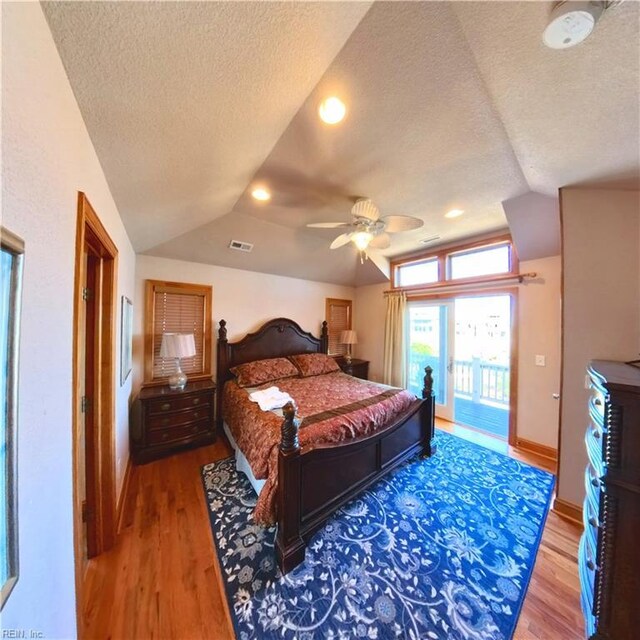 2390 Sandfiddler Rd, Corolla, NC 27927 - bedroom with lofted ceiling, a textured ceiling, wood finished floors, access to outside, and ceiling fan