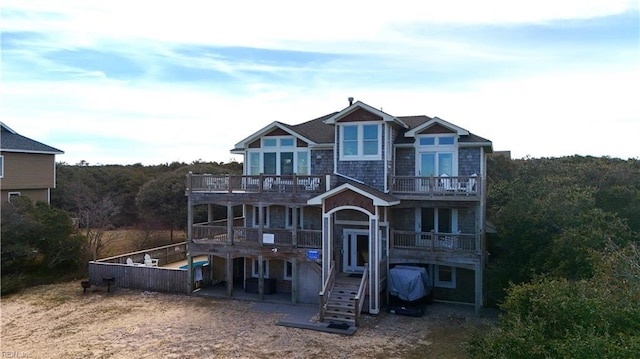 2390 Sandfiddler Rd, Corolla, NC 27927 - view of front of property with a balcony, stairs, a deck, and a patio