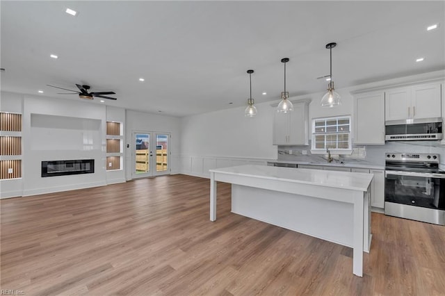 1 Lacrosse St, Hampton, VA 23663 - kitchen featuring appliances with stainless steel finishes, light countertops, ceiling fan, recessed lighting, and a center island