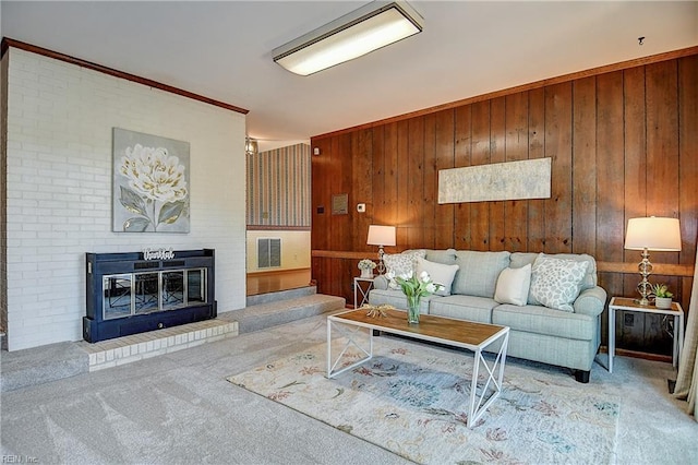 2029 Heron Ct, Suffolk, VA 23433 - carpeted living room with wooden walls, a brick fireplace, and ornamental molding