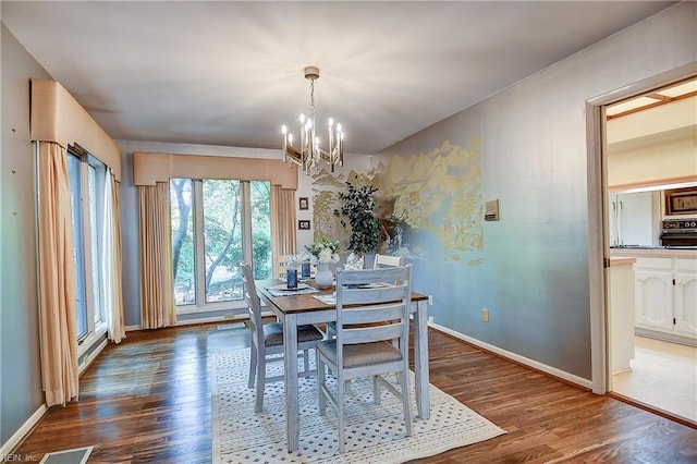2029 Heron Ct, Suffolk, VA 23433 - dining area featuring a chandelier, wood finished floors, and baseboards