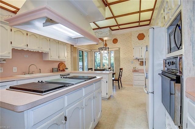 2029 Heron Ct, Suffolk, VA 23433 - kitchen featuring wall oven, a sink, wallpapered walls, a kitchen island, and ventilation hood
