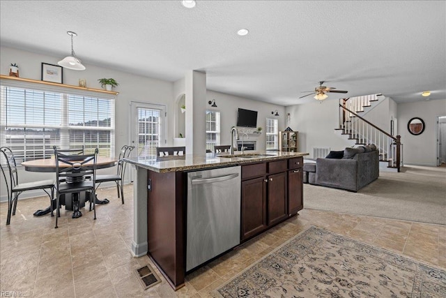 254 Mcpherson Rd, South Mills, NC 27976 - kitchen with dishwasher, a sink, open floor plan, ceiling fan, and dark brown cabinets