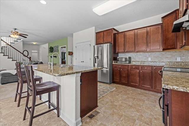 254 Mcpherson Rd, South Mills, NC 27976 - kitchen with appliances with stainless steel finishes, light stone counters, exhaust hood, and open floor plan