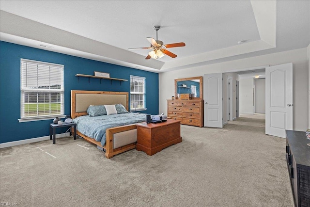 254 Mcpherson Rd, South Mills, NC 27976 - carpeted bedroom featuring a raised ceiling, multiple windows, baseboards, and ceiling fan