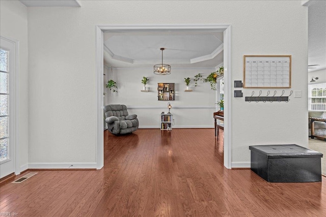 254 Mcpherson Rd, South Mills, NC 27976 - hallway featuring wood finished floors, ornamental molding, plenty of natural light, baseboards, and a chandelier