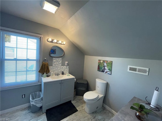 220 Chesterfield Rd, Hampton, VA 23661 - bathroom featuring vaulted ceiling, marble look tile flooring, vanity, and healthy amount of natural light