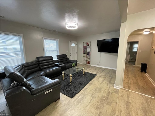 220 Chesterfield Rd, Hampton, VA 23661 - living room featuring arched walkways, light wood-style flooring, and baseboards
