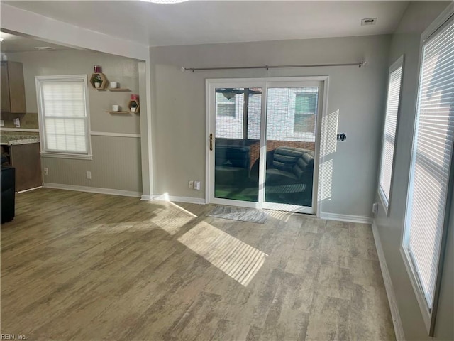 220 Chesterfield Rd, Hampton, VA 23661 - spare room featuring wood finished floors, healthy amount of natural light, baseboards, and wainscoting