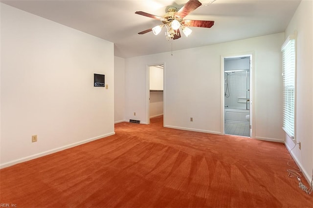 205 Shackleford Rd, Yorktown, VA 23693 - unfurnished bedroom with baseboards, light carpet, a walk in closet, ensuite bathroom, and a ceiling fan