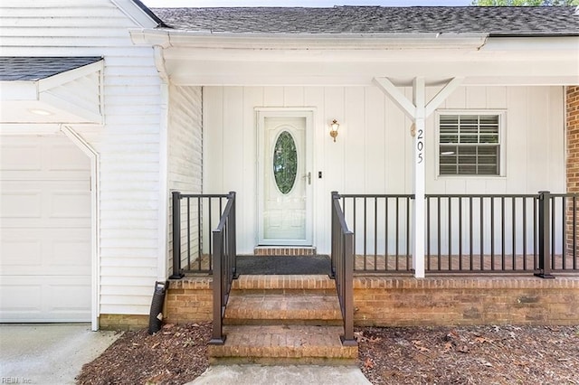 205 Shackleford Rd, Yorktown, VA 23693 - view of exterior entry with roof with shingles, a garage, and a porch