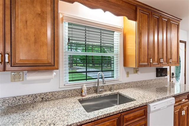 205 Shackleford Rd, Yorktown, VA 23693 - kitchen featuring white dishwasher, a sink, brown cabinetry, and light stone counters