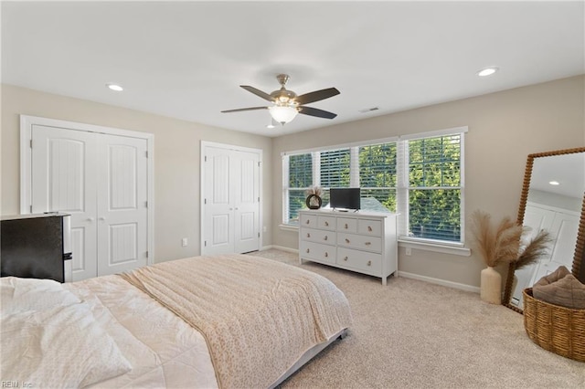 bedroom featuring multiple closets, baseboards, recessed lighting, carpet, and ceiling fan