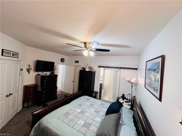 bedroom featuring carpet floors, a ceiling fan, and a barn door