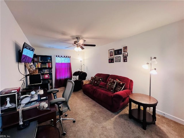 carpeted home office featuring ceiling fan and baseboards