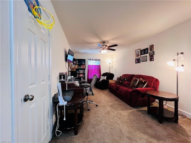 carpeted office with a ceiling fan