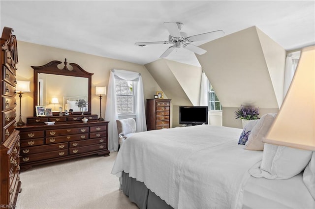 bedroom with multiple windows, light colored carpet, a ceiling fan, and vaulted ceiling