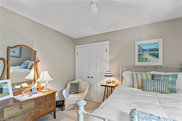 carpeted bedroom featuring a closet and ceiling fan