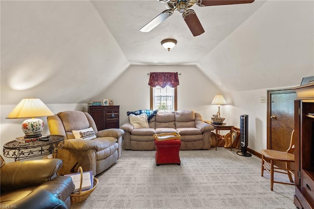 living room with a ceiling fan, light colored carpet, lofted ceiling, and baseboards