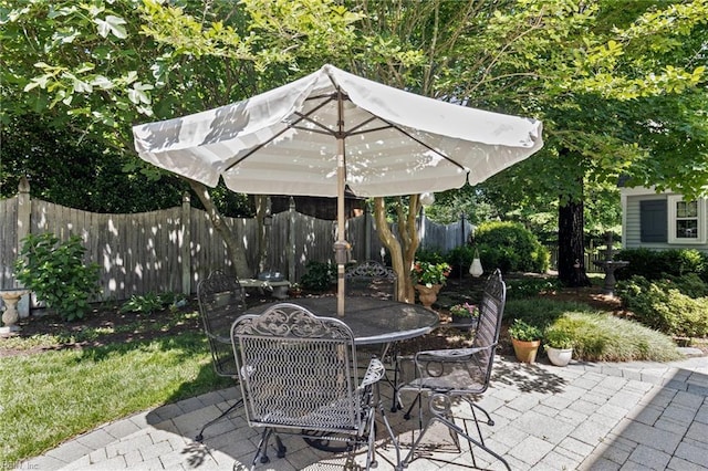 view of patio featuring fence and outdoor dining area