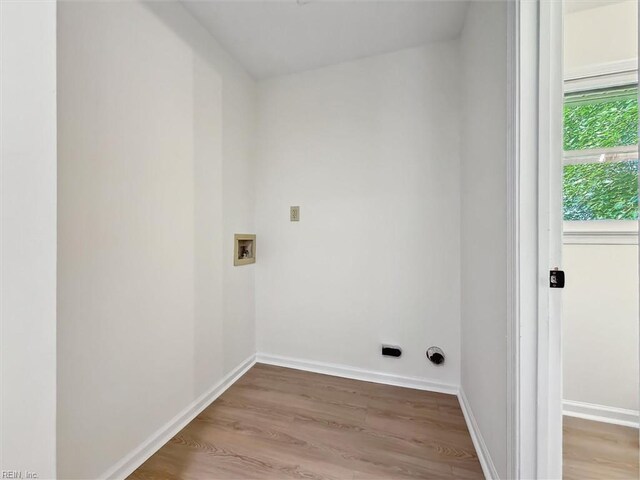 laundry room with wood finished floors, washer hookup, and baseboards