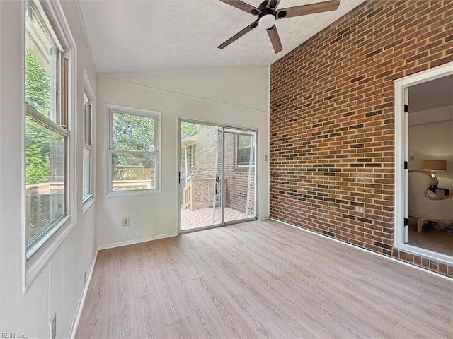 unfurnished sunroom with lofted ceiling