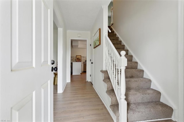 stairway with wood finished floors